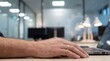© Tantri - Close-up of a persons hands typing on a laptop on a desk with a blurred modern office background and a translucent gear icon