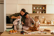 © La Famiglia - Family baking together in kitchen preparing sweet treats