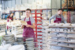 © JackF - Young female factory worker posing with finished ceramic dishes