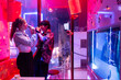© Luis Velasco/Stocksy - Friends Enjoying Karaoke Night in a Vibrant Bar Setting