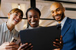 © BONNINSTUDIO/Stocksy - Business team collaborating using digital tablet