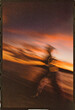 © Ryan Tuttle/Stocksy - Blurry photo of woman running on the beach at sunset