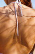 © Artem Podrez/Stocksy - Close-Up of Woman’s Back in Summer Sunlight With Shadows and Swimwear
