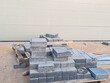 © Usama - Interlocking pavers, small brick-like tiles, for pavement areas, walkways, pedestrian crossings and paved pathways Interlock pallets on construction site, ready for installation on landscaping paving.