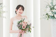 © buritora - 結婚式場でブーケを持つ花嫁・新婦の女性