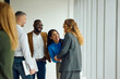 © Boris Jovanovic/Stocksy - Staff members talking in the hallway