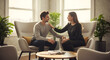 © BornHappy - A man and woman sit in modern armchairs sharing an emotional moment