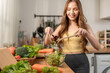 © Kawee - Asian young woman cooking healthy foods in kitchen in morning at home.