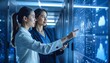 © Yellyana - Two professional business women discussing while pointing at digital dashboard in data center, cloud computing infrastructure, modern corporate environment, blue tone lighting, realistic photography,