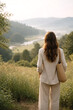 © Moddy - A woman surveys the beautiful scenery of a valley with the morning mist gently settling