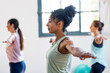 © Westend61 - Women practicing balance and concentration during a fitness class indoors