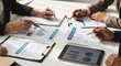 © MUGU STD - Business team analyzing financial reports and data charts
