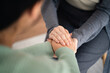 © Suriyawut - Psychologist or family holding hands to encourage patient with depression, mental health concept