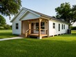 © Nandi - Small white house with covered porch and green lawn