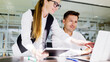 © muse studio - Team members working together at a desk in a modern office during the day