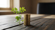 © elkhan - A small green plant growing from a wooden table next to a stack of gold coins, symbolizing financial growth and investment.