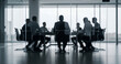 © Vhagar - Professional team engaged in strategic discussion inside a sleek office boardroom, surrounded by glass panels and city views, with soft light and motion blur adding dynamic atmosphere.