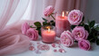 © Anam11 - A luxury spa still life features glowing pink candles and delicate rose petals arranged with soft towels for a relaxing aromatherapy wellness treatment