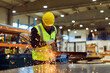 © bnenin - Factory Metalworker Cutting Steel With Angle Grinder Wearing Safety Helmet And High-Visibility Vest