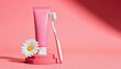 © Oleksandr - Minimalist Oral Care Display: Pink Toothpaste Tube, Toothbrush, and Daisy on Pedestal with Sunlight and Shadows, Clean Hygiene Concept