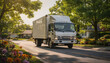 © Oleksandr - White delivery truck on a sunny suburban street, passing houses with green trees and colorful flowers, symbolizing moving, transport, and service
