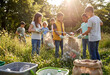 © Olena Smerichka - Group of children collecting recyclable waste in a green park during environmental volunteering activity.