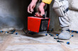 © Natallia - Worker holding and putting electric industrial heat gun for heating large room on construction site.