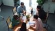© InfiniteFlow - Top view of project manager present financial graph to investors at meeting. Professional marketing team brainstorming financial idea while looking at financial statistic from laptop. Convocation.