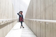 © KONSTANTIN SHISHKIN - Young woman posing in modern concrete architectural space