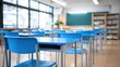 © The Little Hut - Bright and clean classroom interior with blue desks in an orderly setup, ready for education.