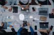 © InfiniteFlow - A diverse team collaborates around a modern office table, utilizing laptops and technology to discuss digital security solutions and innovative data protection strategies. Trope
