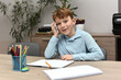 © nellas - Funny little boy using a mobile phone instead of studying, looking shocked and expressive.
