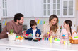 © New Africa - Easter celebration. Family painting eggs at white marble table in kitchen