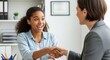 © faustinecontent - Professional women in business attire shaking hands in a modern office setting, conveying partnership and cooperation between colleagues or clients.