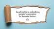 © Asabe - Inspirational quote leadership is unlocking peoples potential to become better on blue background