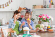 © Pixel-Shot - Teenage girl and her mother with Easter eggs in kitchen