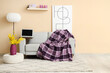 © Pixel-Shot - Interior of living room with plaid and blank laptop on sofa