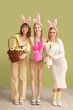 © Pixel-Shot - Young girls with bunny ears celebrating Easter on color background