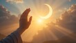 © Malik - Hand reaching for crescent moon at sunrise with sunbeams
