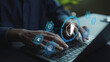 © Pakin - Digital cyber security concept. Person working on laptop with firewall, encryption and shield icons, hacking prevention, data privacy and IT security management.