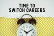 © may1985 - Time To Switch Careers text written on paper with alarm clock on yellow chevron background