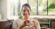 © OnPoint/peopleimages.com - Coffee, home and portrait of happy woman on sofa with drink for wellness, calm and relax in living room. Rest, house and person smile with beverage on couch for peaceful, me time and break on weekend