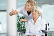 © auremar - senior woman in wheelchair and a lovely nurse