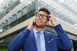 © auremar - young professional man talking on cell scratching his head