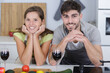 © auremar - image of happy couple with glasses of red in kitchen