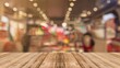 © mila103 - Wooden floor with a table in a store. The table is empty and the floor is made of wood. The image is blurry, giving it a dreamy, ethereal quality