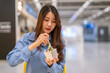 © Art_Photo - Young asian woman eating ice cream cup with wooden spoon in shopping mall, Happy female customer enjoying sweet dessert treat during shopping break, Lifestyle, food court and eco friendly concept