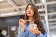 © Art_Photo - Young asian woman eating ice cream cup with wooden spoon in shopping mall, Happy female customer enjoying sweet dessert treat during shopping break, Lifestyle, food court and eco friendly concept