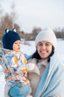 © phpetrunina14 - Smiling Mother and Baby Enjoying a Winter Day