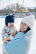 © phpetrunina14 - Smiling Mother and Baby Enjoying a Winter Day